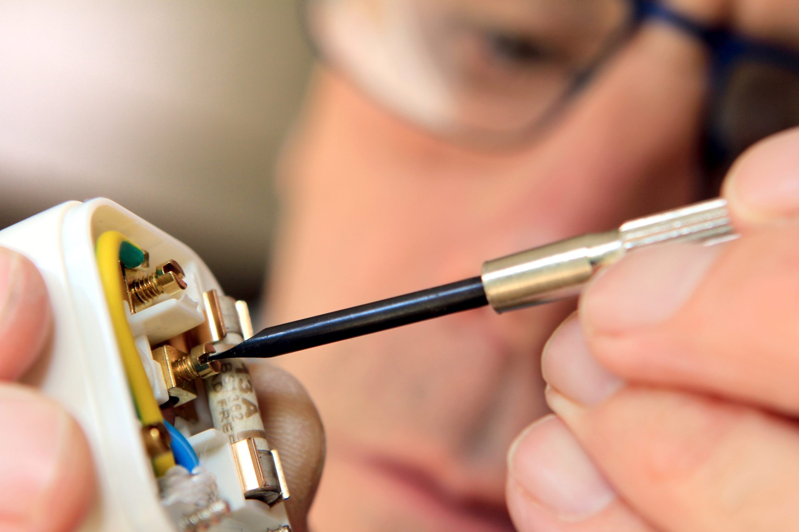 Electrician rewiring a UK 13 amp domestic electric plug