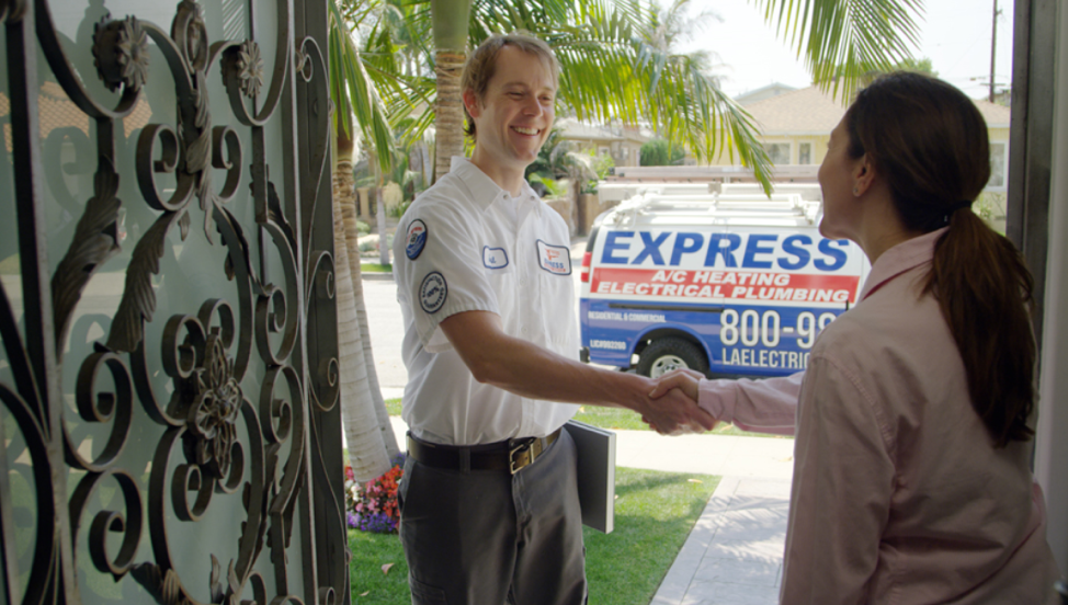 express electrician shaking hands with homeowner