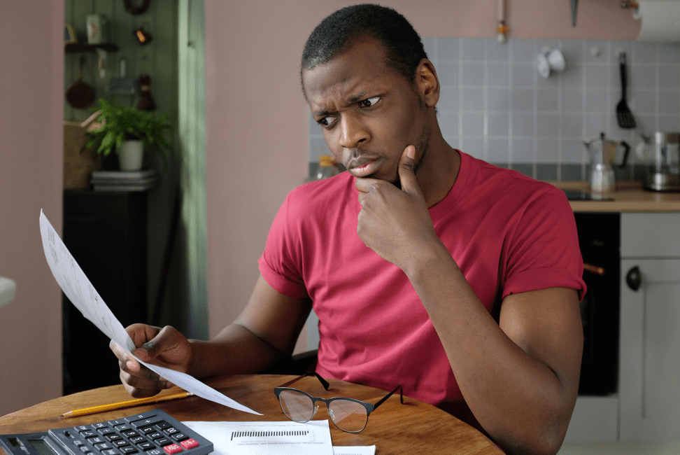 man contemplating electricity bill