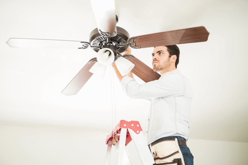 technician installing a ceiling fan