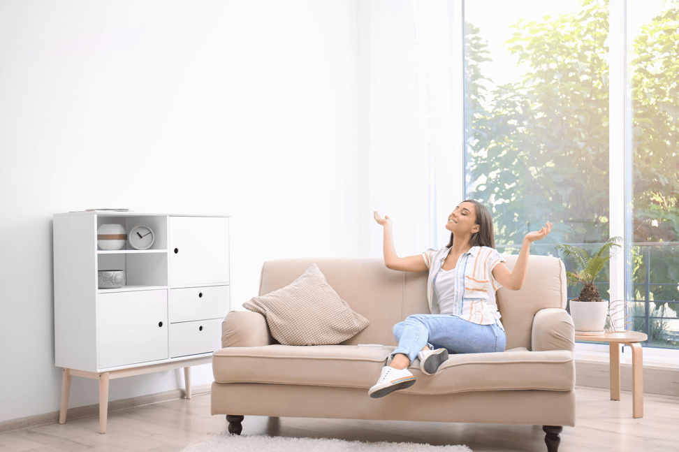 happy-lady-on-couch-enjoying-energy-efficient-house