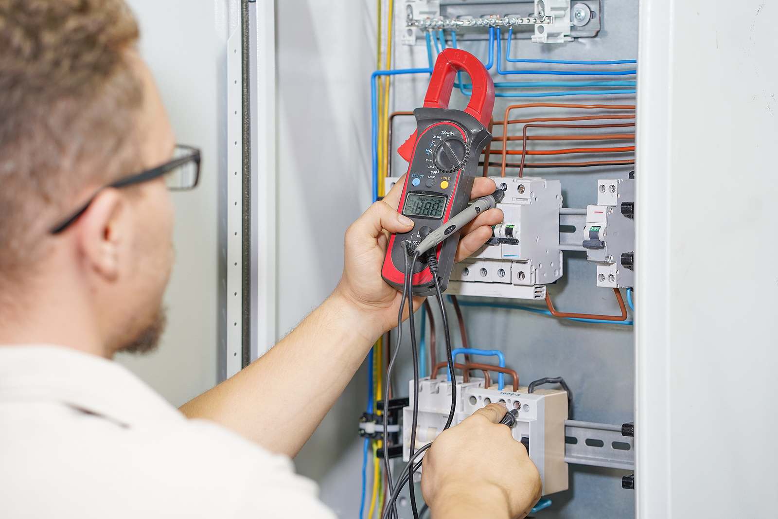 Electrician Measuring Voltage with Multimeter