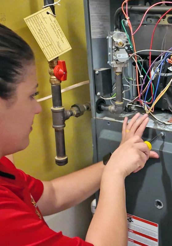 Tech Carrying Out HVAC Repair