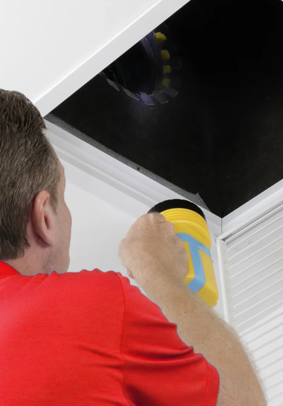 Tech Inspecting Air Duct