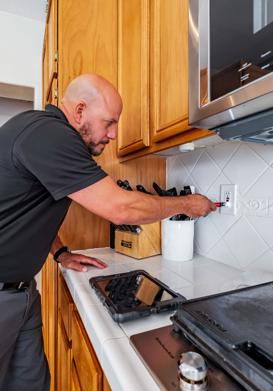 Tech Inspecting Electrical Socket